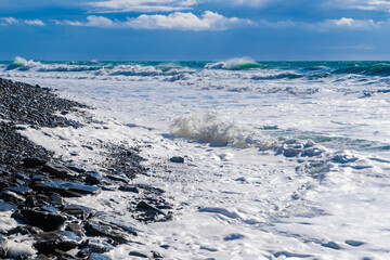 Kabardinka resort. Black sea. Large emerald-colored storm waves roll towards shore. Lots of squirts and foam
