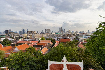 Bangkok cityscape with traditional temple rooftops, residential buildings and modern skyscrapers...