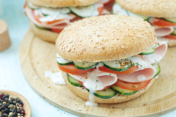 Bun sandwiches with salami and vegetables