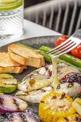 Melted camembert cheese with grilled vegetables and toast