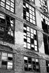broken windows of a brick built abandoned disused factory in the former Soviet Union 
