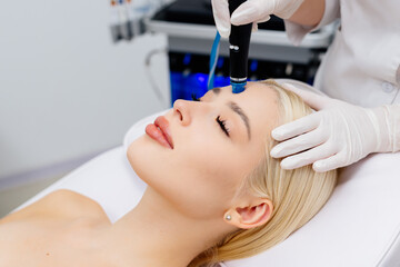 Close-up of a hydra peeling procedure. An unrecognizable cosmetologist performs a hydro peeling...