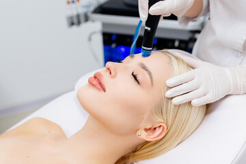 A close-up of a hydra peeling cosmetic procedure. A young woman enjoys the treatment. Concept skin...