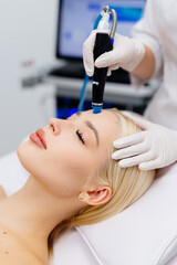A close-up of a hydra peeling cosmetic procedure. A young woman enjoys the treatment. Concept skin...