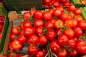 Vibrant red tomatoes displayed in a local market at midday