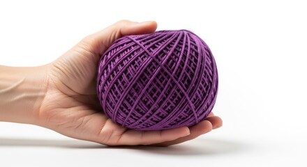 Hand holding a ball of purple yarn, Hand on white background