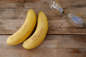 Fresh bananas on wooden table, Ripe yellow bananas, rich in potassium, healthy lifestyle, diet,...