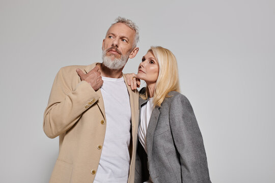 Heartwarming moment between a stylish senior couple embracing their love and fashion together - Powered by Adobe