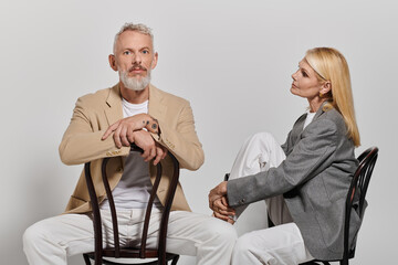 Stylish senior couple showcases elegance and romance in a modern seat arrangement
