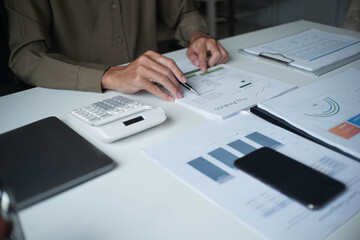 Businessman reading report in office desk analyse data for plan project