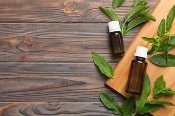 Natural Mint Essential Oil in a Glass Bottle. organic cosmetics with herbal extracts of mint on...