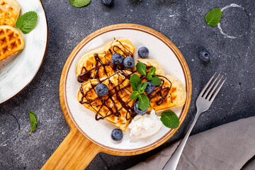 Thin pancakes with chocolate spread and blueberries on the grey background top view
