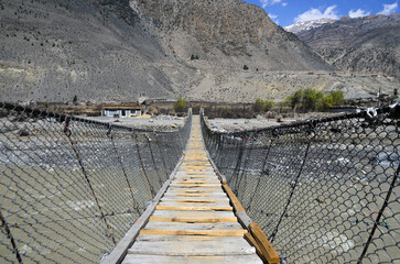 suspension bridge to cross river in Himalayas