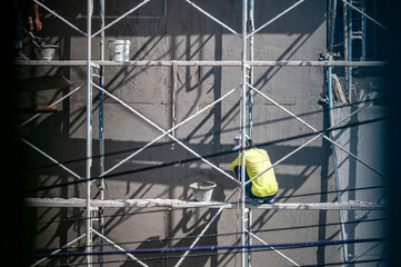 Worker on Scaffolding at Construction Site