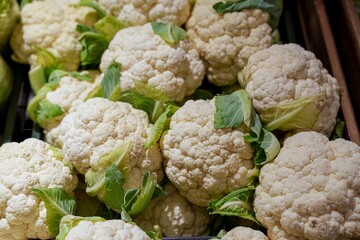 Fresh cauliflower heads on display at supermarket