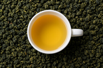 Cup of brewed Milk Oolong tea, aromatic Chinese golden tea close-up