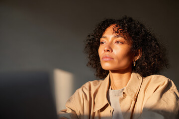 ultrabright minimalist workspace scene featuring focused individual at laptop emphasizing productivity