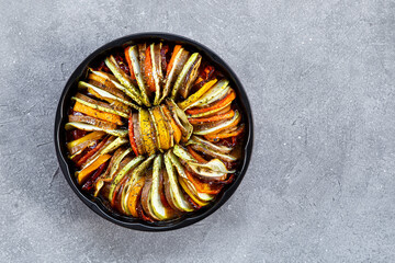 Plate of tasty Ratatouille on grey background top view copy space for text