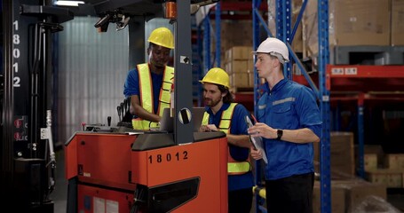 multiracial warehouse team including african american worker caucasian supervisor and manager standing near forklift discussing shipment handling using clipboard and laptop to ensure cargo control - Powered by Adobe