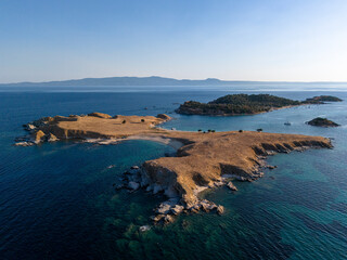 Rocky Island and Boat in Deep Blue Coastal Waters Near Athos, Greece