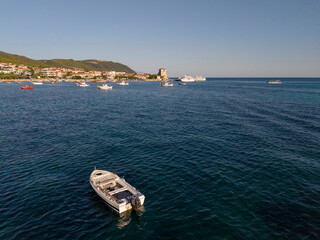 Stone Tower and Boats Along a Serene Coastal Harbor of Ouranoupolis, Greece