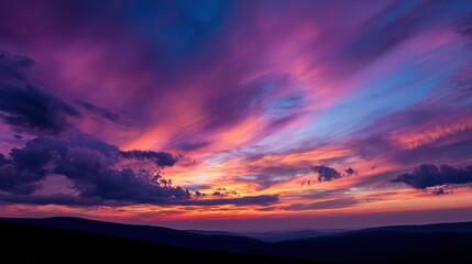 Fototapeta premium The vibrant sunset sky filled with shades of pink, purple, and orange, with clouds forming intricate patterns, further added to the overall beauty of the scene.