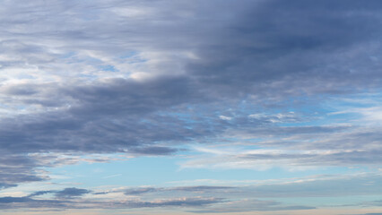 Scattered stratocumulus clouds stretch across a bright sky