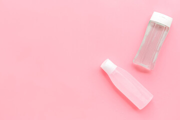 facial tonic and lotion for face care on pink background top view mock up