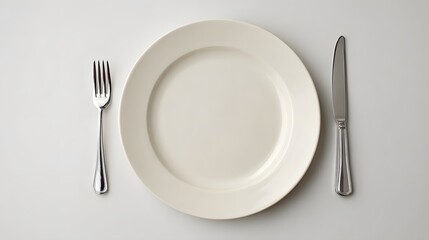 Empty white plate with fork and knife table setting minimal background