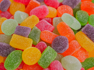 Assorted colorful jelly candies with various flavors, sugar-coated and chewy, displayed in vibrant...