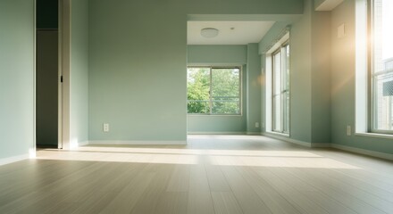 Empty room with light green walls, wood floors, and natural light