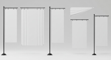 Several tall, vertical flagpoles stand in a row, each holding a blank, rectangular banner, perfect for displaying messages or designs, against a neutral background.