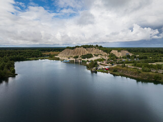 Fototapeta premium Rummu, Estonia - August 24, 2025: High-angle drone shot of the flooded Soviet-era prison, now a popular and unique travel destination.