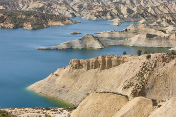 Badlands landscape and blue waters in Algeciras reservoir. Spain