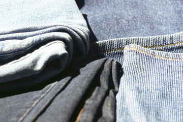 Denim fabric in different shades, close-up. Jeans in daylight. Concept of capsule wardrobe...