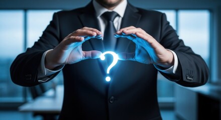 Glowing question mark held between hands of a man in business attire
