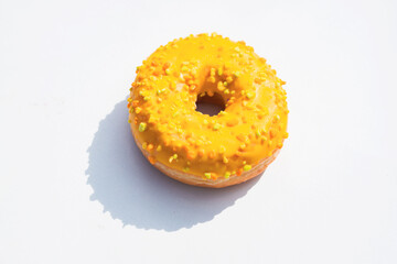 Colorful Sprinkle-Covered Donut on a White Background Showcasing Vibrant Textures and Sweet Appeal