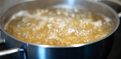Close up noodles or pasta are cooked in a pot. Kitchen at home, preperation lunch or for dinner.