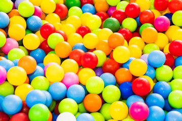 A sea of colorful plastic balls fills a childrens play area inviting kids to jump in and enjoy the vibrant atmosphere Sunlight enhances the playful setting creating joy