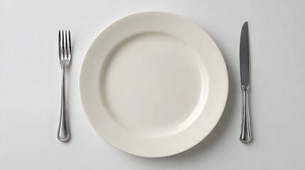 Empty white plate with fork and knife table setting minimal background