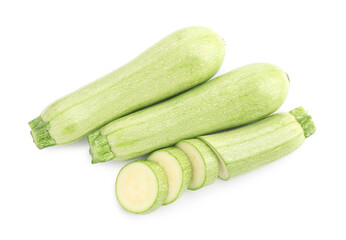 Fresh whole and cut zucchinis isolated on white, top view