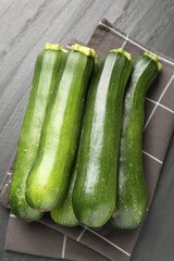 Fresh ripe zucchinis on black table, top view