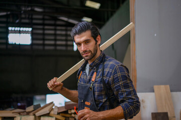 Carpenter is working at workshop.
