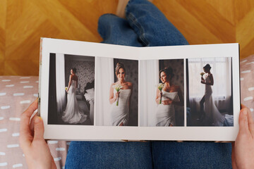 Female hands flipping through a photo book with wedding photos