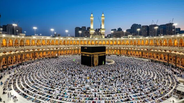 Aerial View of Kaaba and Masjid al-Haram at Evening Prayer - A stunning aerial shot captures the Kaaba at the center of the Masjid al-Haram during evening prayers.