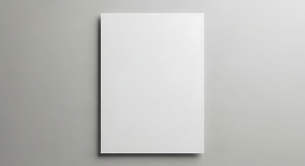Clean minimalist mockup of a blank rectangular poster on a soft gray wall surface.