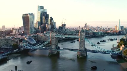 Aerial view of the london skyline at sunset, featuring the iconic tower bridge and modern skyscrapers along the river thames - Powered by Adobe