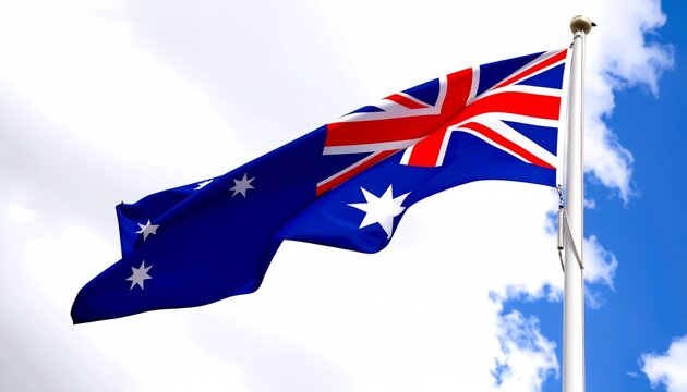 Australian flag flying on flagpole against partly cloudy sky