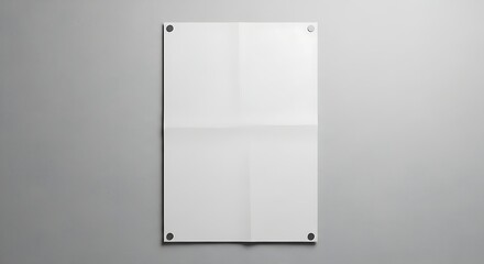 A white folded poster mockup is attached to a gray wall with four fasteners.