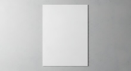 A vertical white poster stands against a subtly textured concrete wall in soft, natural light,